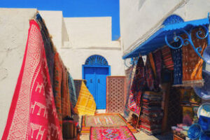 Traditional Tunesian carpets hanging on blue walls